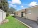 Enclosed backyard featuring patio, garden, and access to home at 1487 Gantt St, The Villages, FL 32162