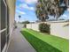 Private backyard featuring verdant artificial turf, patio, and tasteful landscaping at 1487 Gantt St, The Villages, FL 32162