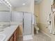 Bathroom featuring a double vanity, enclosed shower, and convenient towel racks for a functional space at 1487 Gantt St, The Villages, FL 32162