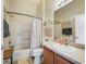 Cozy bathroom featuring a tub with shower, toilet, vanity, and large mirror at 1487 Gantt St, The Villages, FL 32162