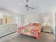 Bright bedroom featuring floral bedding, ample closet space, and a well-lit dressing area at 1487 Gantt St, The Villages, FL 32162