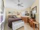 Comfortable bedroom featuring a ceiling fan, dresser, and charming decorative touches throughout the space at 1487 Gantt St, The Villages, FL 32162