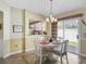 Inviting dining area featuring a round table with seating for four and a sliding glass door to the patio at 1487 Gantt St, The Villages, FL 32162