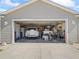 Spacious garage holding two vehicles and other equipment and tools at 1487 Gantt St, The Villages, FL 32162
