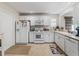 Bright kitchen features white cabinets, modern appliances, and ample counter space, perfect for cooking at 1487 Gantt St, The Villages, FL 32162