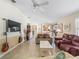 Open floor plan featuring a large TV, guitars, and cozy seating perfect for relaxation and entertainment at 1487 Gantt St, The Villages, FL 32162