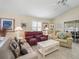 Bright living room with tile floors, neutral paint, and ample seating for entertaining and relaxing at 1487 Gantt St, The Villages, FL 32162