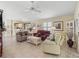 Open-concept living room showcases tile flooring, comfortable seating, and a seamless flow into the dining area at 1487 Gantt St, The Villages, FL 32162