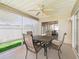 Inviting screened patio featuring a dining table and ceiling fan for comfortable outdoor living at 1487 Gantt St, The Villages, FL 32162