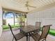 Enclosed patio with dining set, offering a delightful outdoor living space with views of the well-maintained backyard at 1487 Gantt St, The Villages, FL 32162