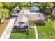 Aerial view of a single-Gathering home with a large yard, mature trees, and a screened-in pool area at 1494 Grace Lake Cir, Longwood, FL 32750