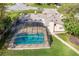A picturesque aerial view of the house with screened-in pool and lush yard at 1494 Grace Lake Cir, Longwood, FL 32750