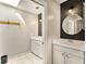 Tastefully updated bathroom features stylish vanity, round mirror, shiplap wall and shower area at 1494 Grace Lake Cir, Longwood, FL 32750