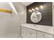 Updated bathroom with a modern vanity, round mirror, and stylish black and white shiplap accent wall at 1494 Grace Lake Cir, Longwood, FL 32750