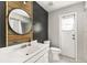 Contemporary bathroom featuring a shiplap accent wall, round mirror, and access to the backyard at 1494 Grace Lake Cir, Longwood, FL 32750