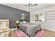 Cozy bedroom offers a decorative accent wall and ample natural light from the window at 1494 Grace Lake Cir, Longwood, FL 32750