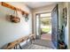 Bright and inviting foyer with wood-look flooring, coat rack, bench and a clear view of the front yard at 1494 Grace Lake Cir, Longwood, FL 32750