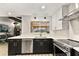 Updated kitchen with black and white cabinets, stainless steel appliances and a view to the lanai at 1494 Grace Lake Cir, Longwood, FL 32750