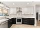 Well-lit kitchen with modern stainless steel appliances, sleek cabinets, and updated lighting fixtures at 1494 Grace Lake Cir, Longwood, FL 32750