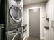 Efficient laundry room with gray washer and dryer, neutral walls, and built-in storage at 1494 Grace Lake Cir, Longwood, FL 32750