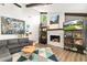 Living room with a stone fireplace, ceiling beams, modern art, and a comfortable gray sofa at 1494 Grace Lake Cir, Longwood, FL 32750