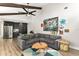 Open concept living room with a comfortable sectional sofa, stainless steel fridge, and modern art at 1494 Grace Lake Cir, Longwood, FL 32750