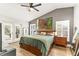 Main bedroom with wood floors, French doors leading to the outside, and modern decor at 1494 Grace Lake Cir, Longwood, FL 32750