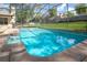 This stunning in-ground pool offers a refreshing escape with its sparkling waters at 1494 Grace Lake Cir, Longwood, FL 32750