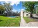 An alluring pool with a screened enclosure and luscious landscaping at 1494 Grace Lake Cir, Longwood, FL 32750