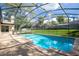 Inviting in-ground pool enclosed with a screened lanai, offering a private outdoor space for relaxation and recreation at 1494 Grace Lake Cir, Longwood, FL 32750