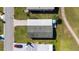 High-angle shot of home's roof with brick-paved driveway, tidy landscaping, and adjacent golf course at 1510 E Schwartz Blvd, The Villages, FL 32159