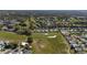 Charming aerial perspective of houses bordering a golf course with well-placed sand traps and green scenery at 1510 E Schwartz Blvd, The Villages, FL 32159