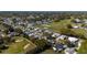 Extensive aerial view of the neighborhood featuring a golf course and lake at 1510 E Schwartz Blvd, The Villages, FL 32159