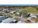 Neighborhood aerial view of homes in a golf course community with green lawns and tree lined streets at 1510 E Schwartz Blvd, The Villages, FL 32159