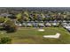 Scenic aerial view of homes nestled along a lush golf course with mature trees and serene community surroundings at 1510 E Schwartz Blvd, The Villages, FL 32159