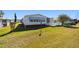 Exterior shot of a well-kept home with tidy landscaping, showcasing its curb appeal and inviting atmosphere at 1510 E Schwartz Blvd, The Villages, FL 32159
