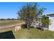 Exterior view of the home with a patio area, landscaped yard, and beautiful surroundings at 1510 E Schwartz Blvd, The Villages, FL 32159