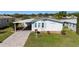 Charming single-story home with a well-manicured lawn, covered parking, and quaint curb appeal at 1510 E Schwartz Blvd, The Villages, FL 32159
