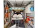 Garage interior featuring a golf cart, storage cabinets, and pegboards for tools and accessories at 1510 E Schwartz Blvd, The Villages, FL 32159