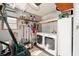 Functional laundry room with washer, dryer, storage shelving, and organized space for cleaning supplies at 1510 E Schwartz Blvd, The Villages, FL 32159
