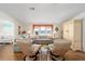 Well-lit living room featuring two swivel chairs and a large sofa at 1510 E Schwartz Blvd, The Villages, FL 32159