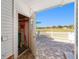 Patio view from storage room featuring brick pavers, white railings, and scenic views of the golf course at 1510 E Schwartz Blvd, The Villages, FL 32159