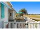 Charming patio with brick pavers, white railings, and an umbrella-covered table overlooking a green lawn at 1510 E Schwartz Blvd, The Villages, FL 32159