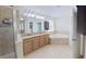 Bathroom featuring a double sink vanity, bathtub, and glass-enclosed shower at 15475 Camp Dubois Cres, Winter Garden, FL 34787