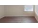 Bedroom featuring wood-look flooring, base molding, and a bright window at 15475 Camp Dubois Cres, Winter Garden, FL 34787