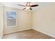 An empty bedroom with luxury vinyl flooring and a bright window at 15475 Camp Dubois Cres, Winter Garden, FL 34787
