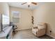 An adaptable bedroom featuring sleek floors, a ceiling fan, and a comfortable seating area at 15475 Camp Dubois Cres, Winter Garden, FL 34787