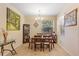 Bright dining room with a large window, tile floors, and a traditional chandelier at 15475 Camp Dubois Cres, Winter Garden, FL 34787