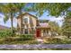 Charming two-story home with a bright red front door and a meticulously landscaped front yard at 15475 Camp Dubois Cres, Winter Garden, FL 34787