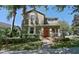 Charming two-story home with a bright red front door and a meticulously landscaped front yard at 15475 Camp Dubois Cres, Winter Garden, FL 34787